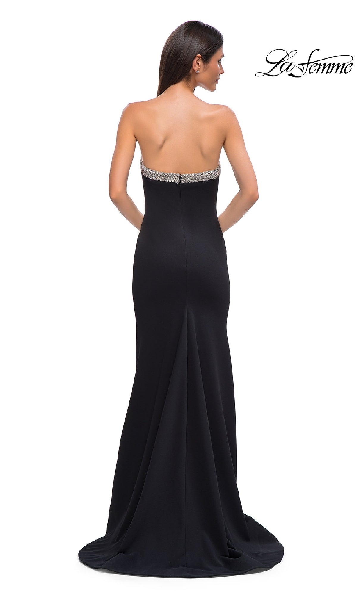 A woman stands with her back to the camera in the Bead-Trimmed Long Prom Dress: La Femme 32891, featuring a strapless design and beaded trim at the top. The La Femme logo appears in the upper right corner.